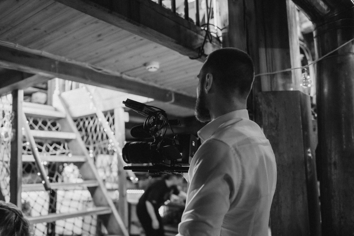 Bastian filming up close during a wedding reception