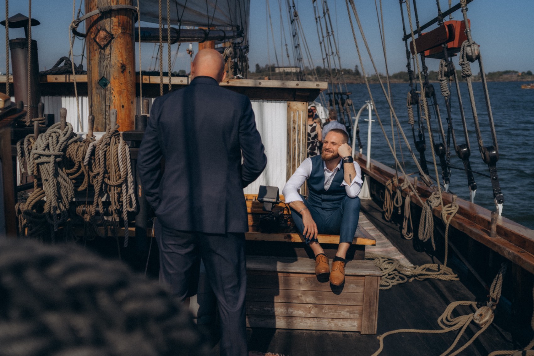 Bastian filming the groom relaxing on the deck of a sailing ship